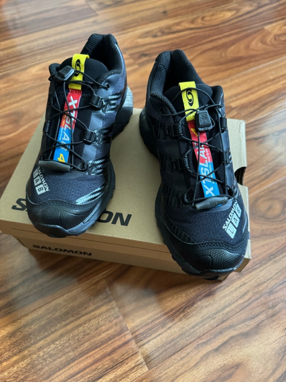 Salomon Black Trail Runners with Yellow and Red Pull Tabs